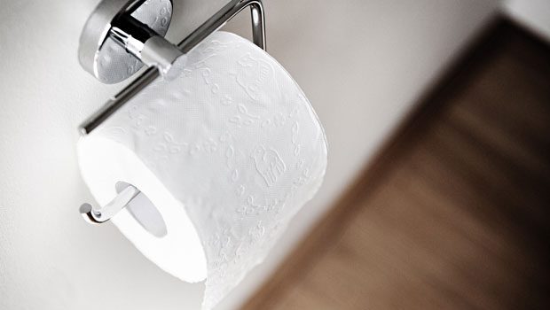 Toilet paper on a holder.